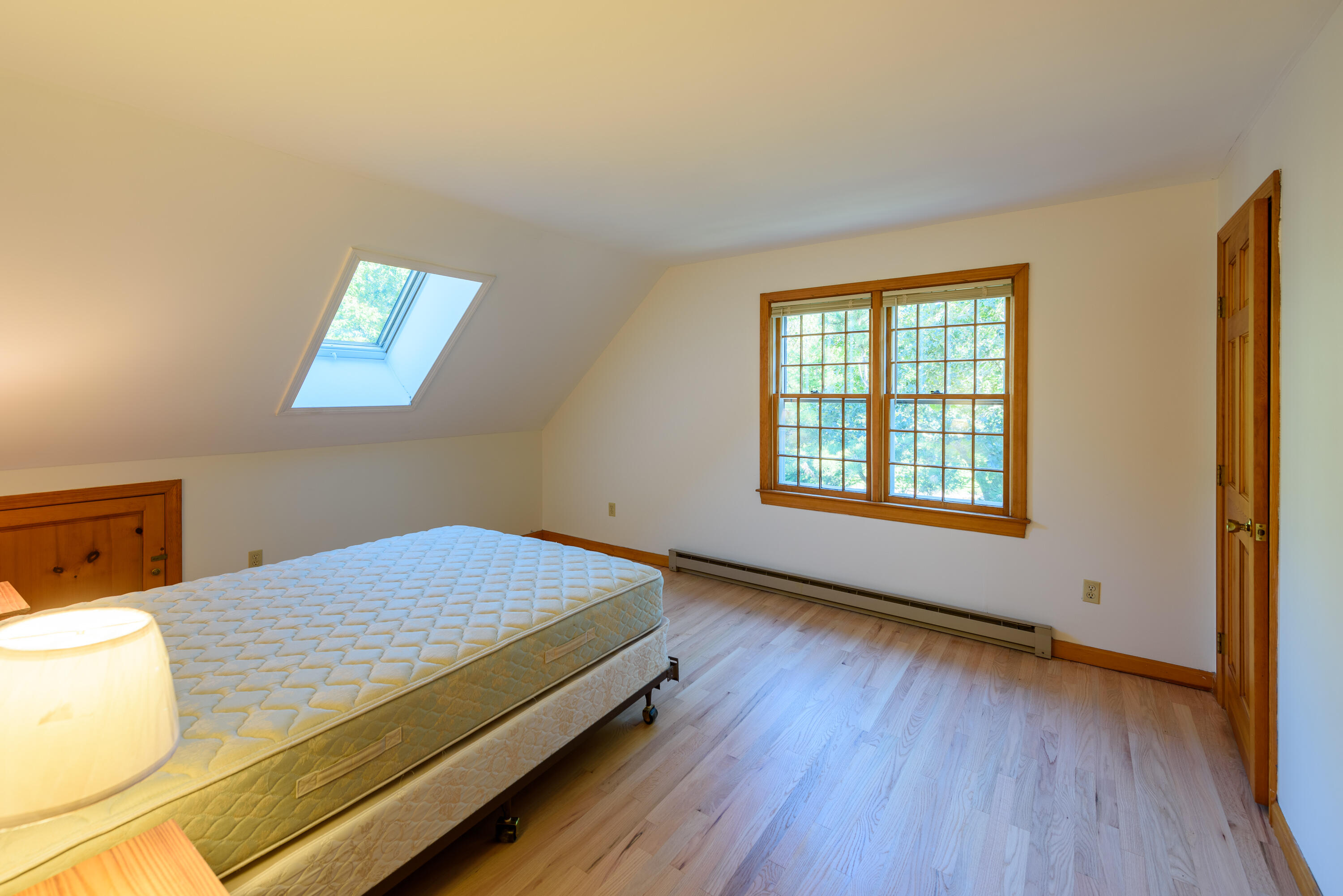 44 Marthas Road Edgartown, MA 02539 - Photo 29 of 30 a bedroom with a bed and wooden floor