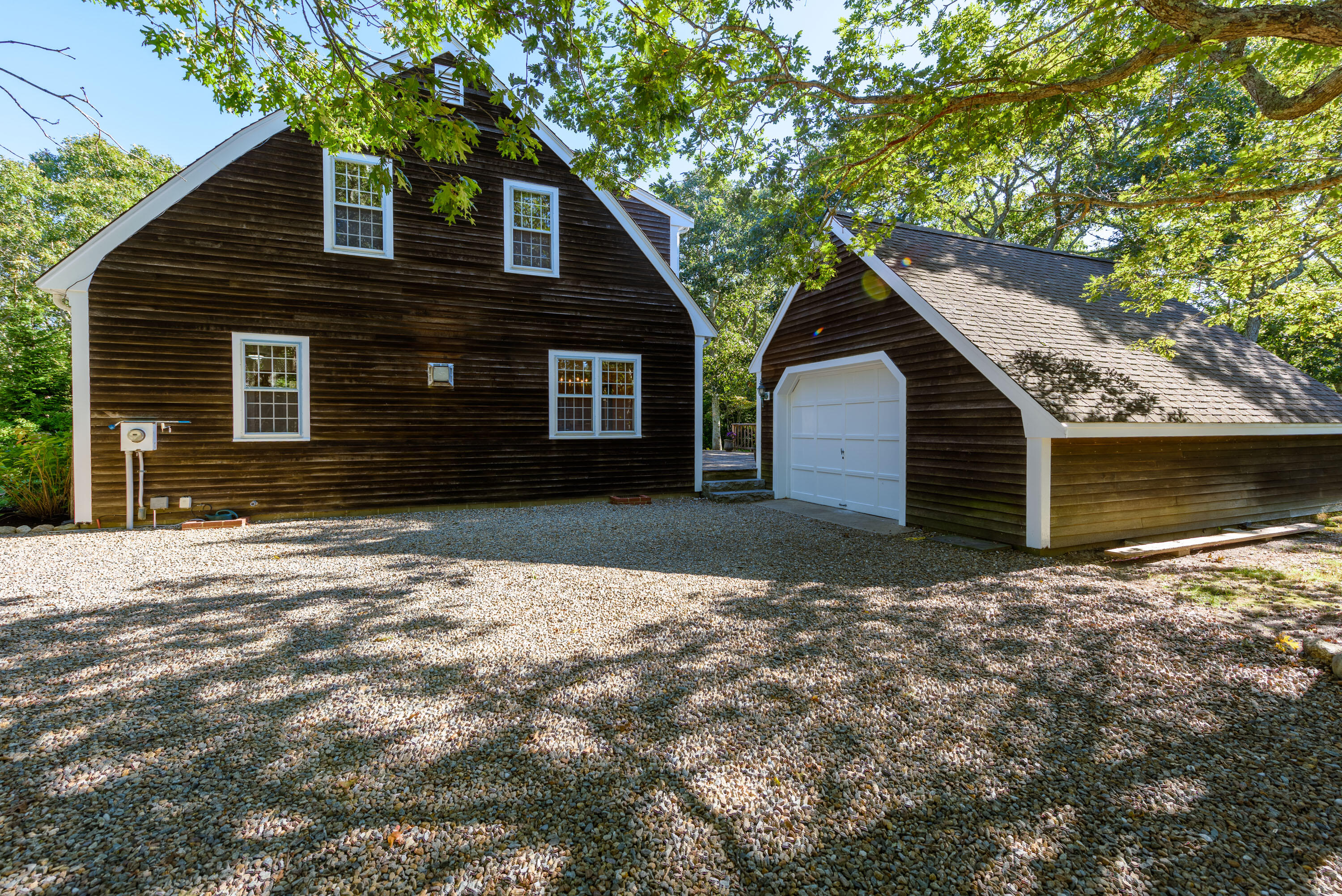 44 Marthas Road Edgartown, MA 02539 - Photo 5 of 30 a front view of a house with a yard and garage