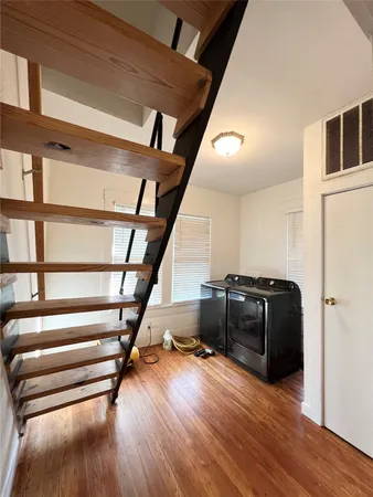 a view of entryway and hall with wooden floor