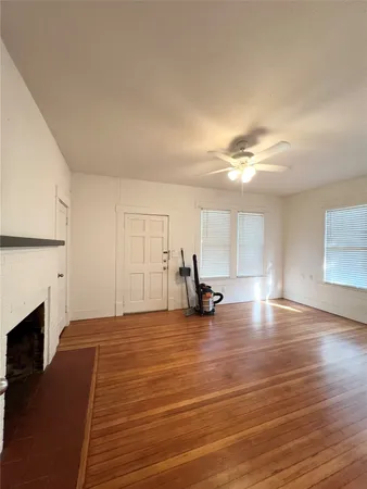 a view of a room with wooden floor and fireplace