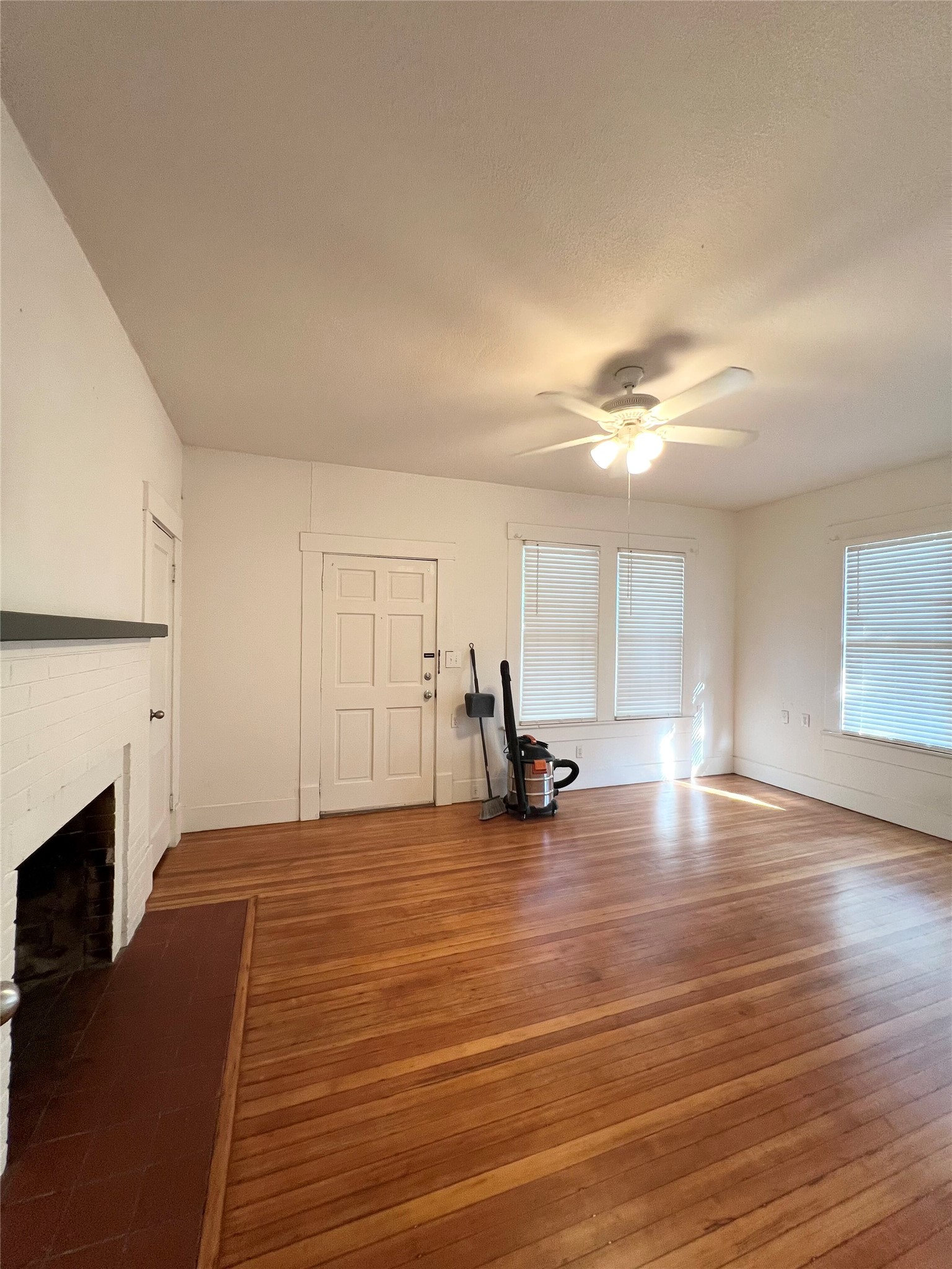 407 West 35th Street, Unit A Austin, TX 78705 - Photo 3 of 20 a view of a room with wooden floor and fireplace