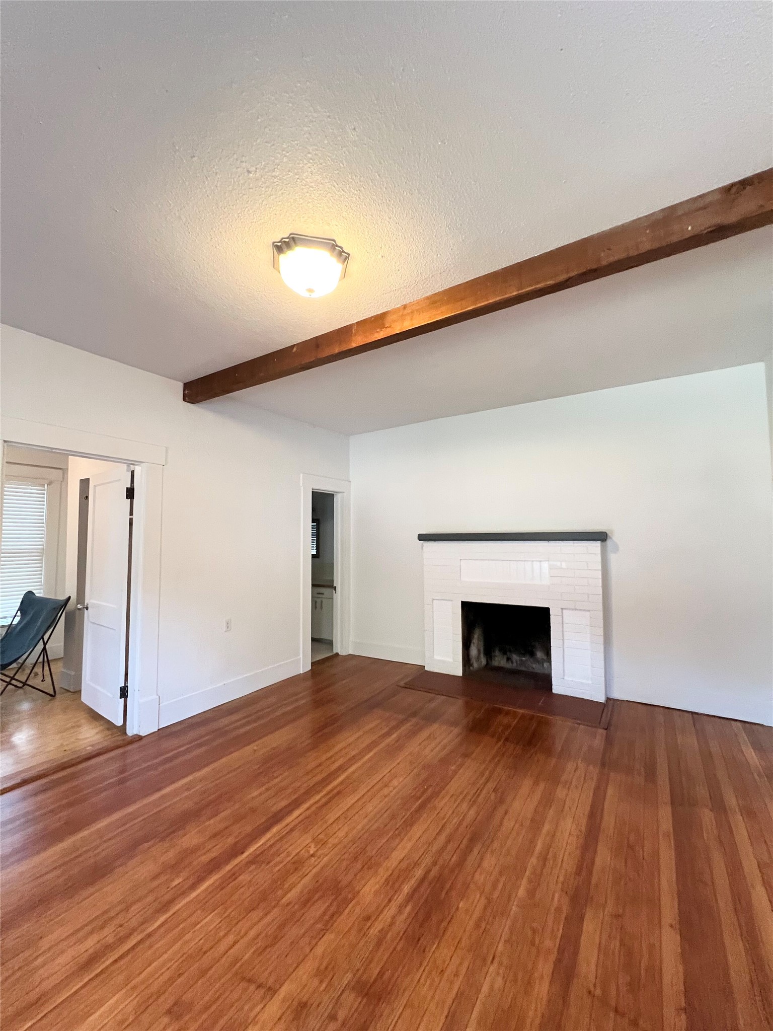 407 West 35th Street, Unit A Austin, TX 78705 - Photo 4 of 20 a view of an empty room with wooden floor and a window