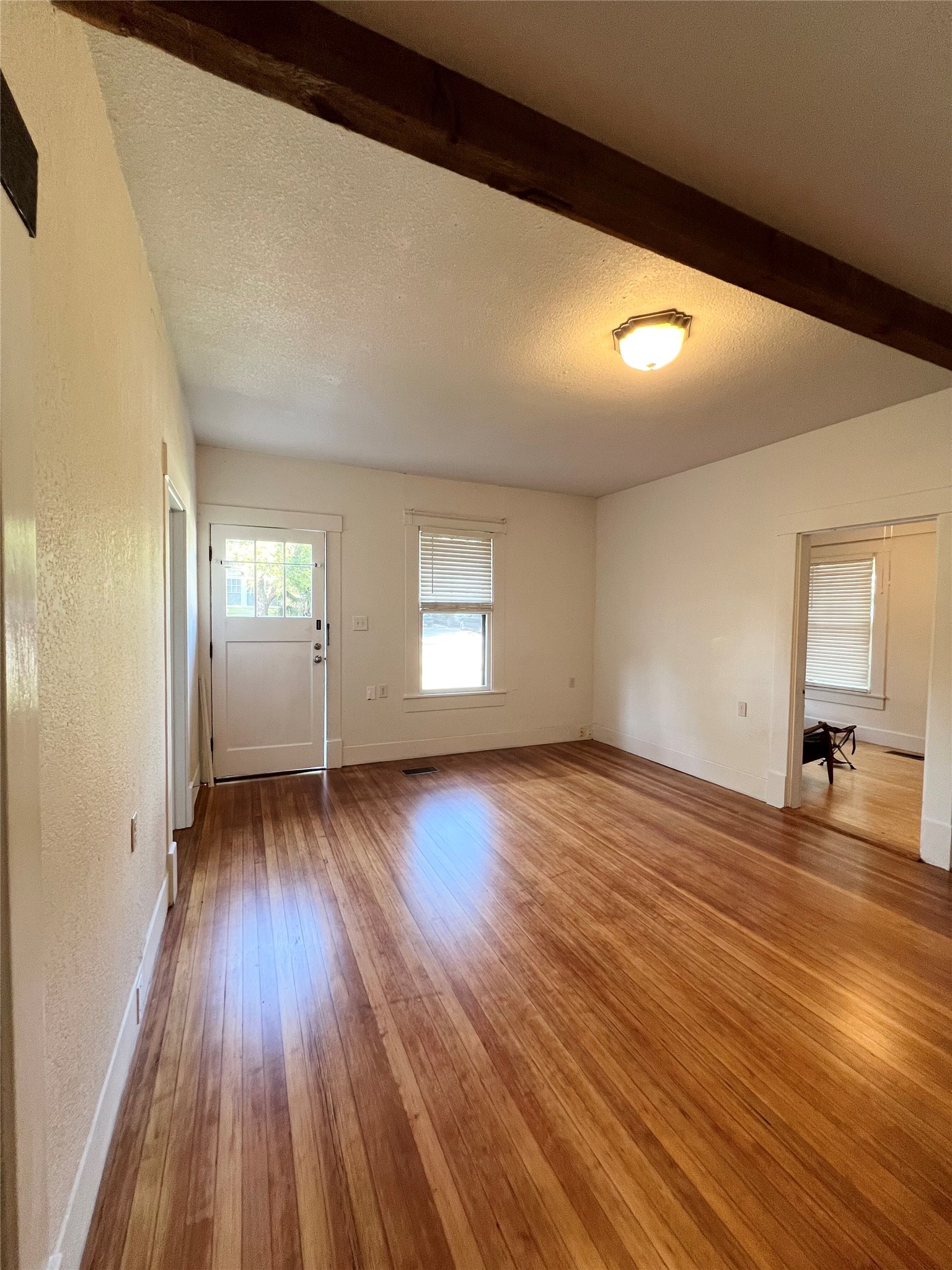 407 West 35th Street, Unit A Austin, TX 78705 - Photo 6 of 20 wooden floor in an empty room with a window