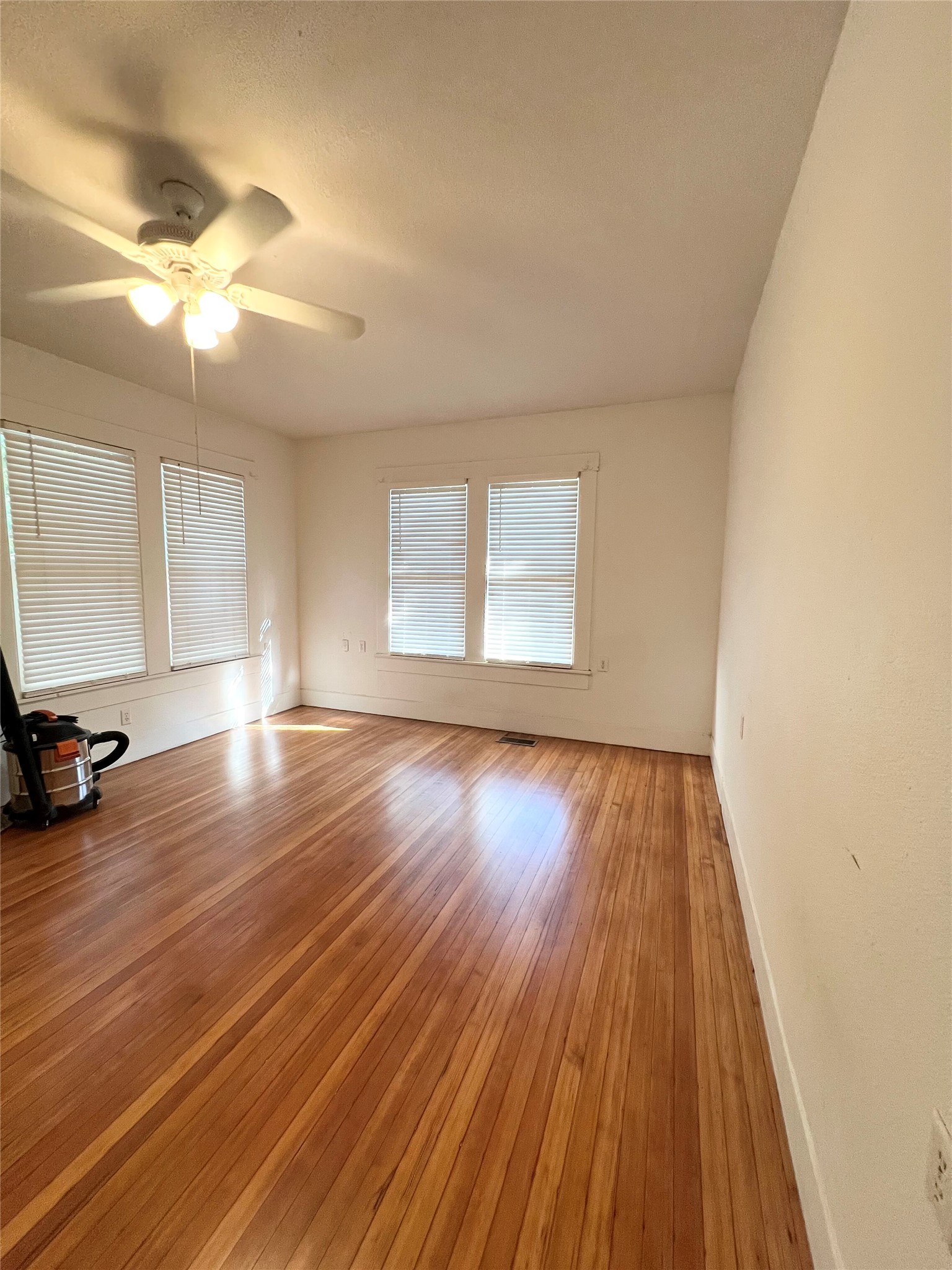 407 West 35th Street, Unit A Austin, TX 78705 - Photo 9 of 20 a view of a room with wooden floor and window