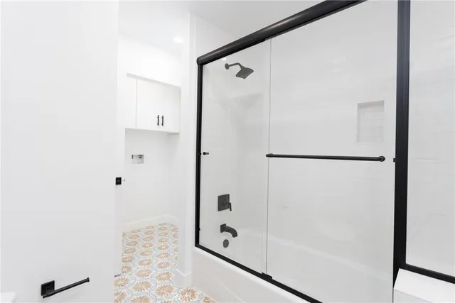 a bathroom with a shower and a glass door