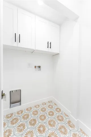 a view of kitchen with white cabinets