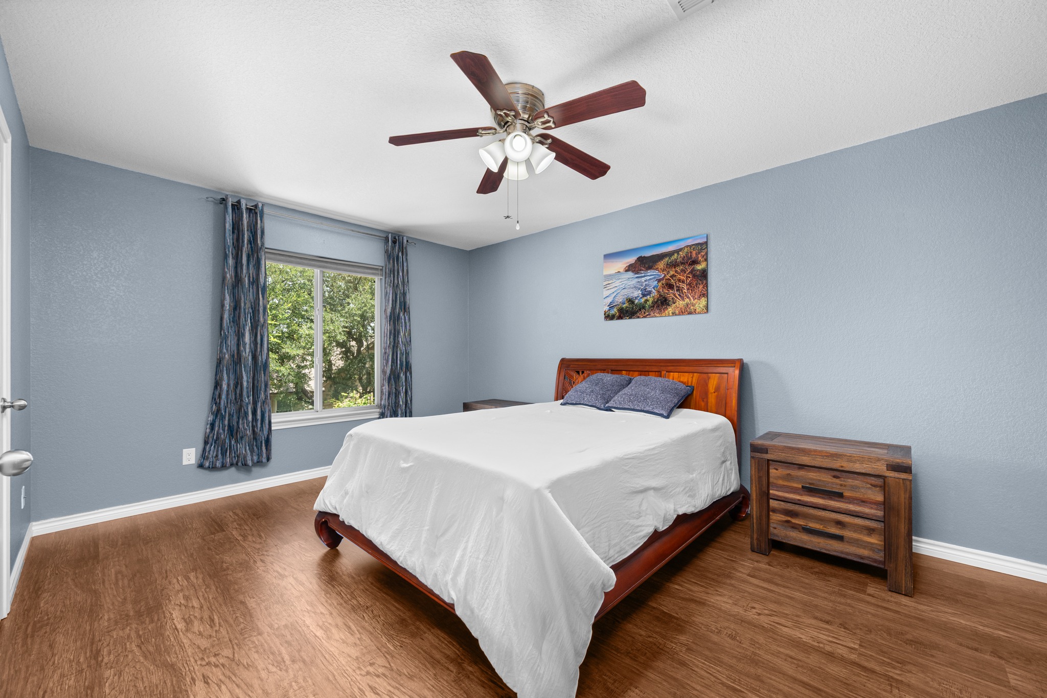 108 Thornwood Road Georgetown, TX 78628 - Photo 31 of 40 A well-lit bedroom featuring rich hardwood flooring and a refreshing ceiling fan for comfort.