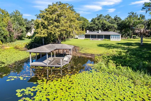 a swimming pool with outdoor seating and yard