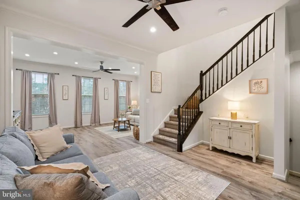 a living room with furniture and stairs