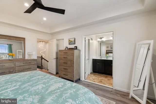 a spacious bedroom with a bed and a dresser