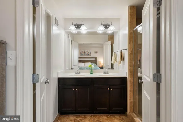 a bathroom with a double vanity sink and a mirror