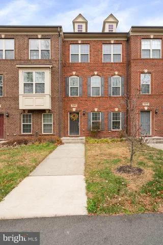 a front view of a residential apartment building with a yard