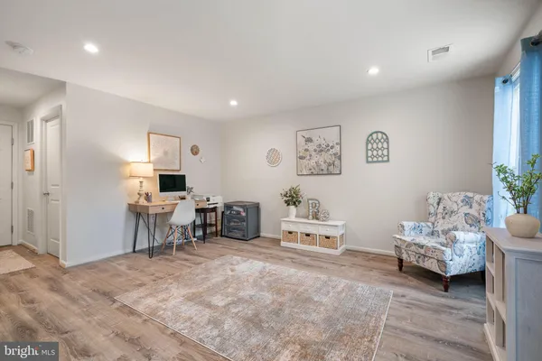 a living room with furniture and a chair