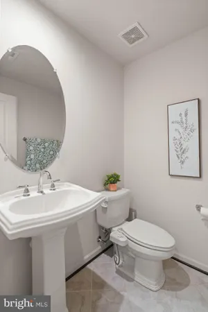 a bathroom with a sink toilet and a mirror