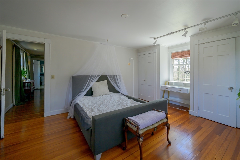 380 South Street Boston, MA 02130 - Photo 4 of 19 a bedroom with a bed and wooden floor