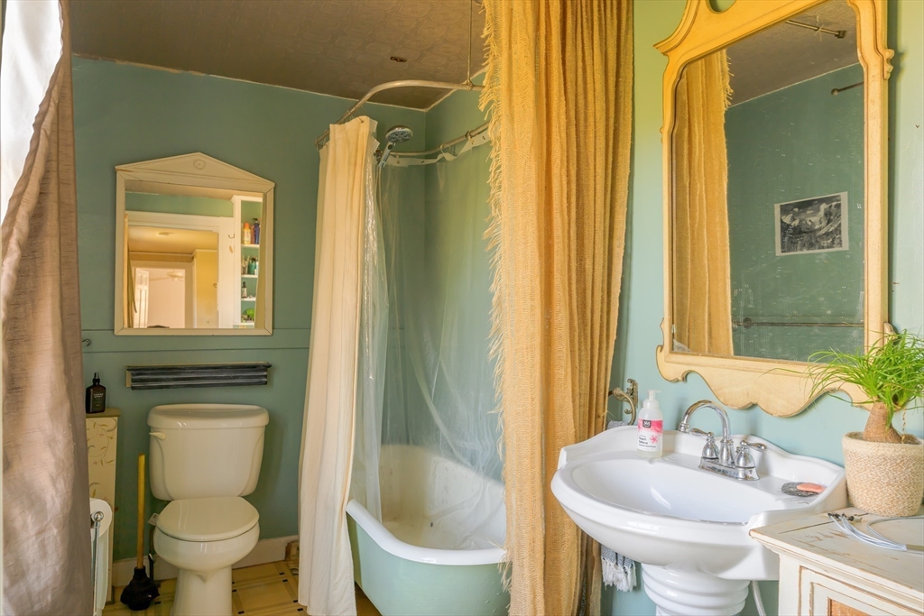 380 South Street Boston, MA 02130 - Photo 5 of 19 a bathroom with a toilet a sink and a mirror