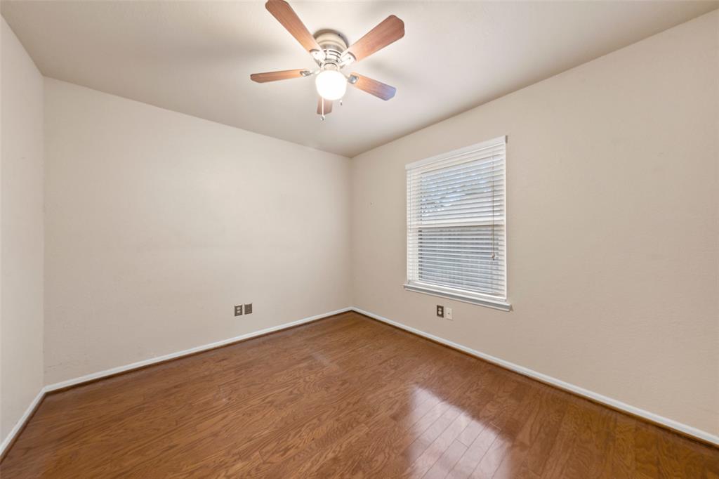 712 North Old Robinson Road Robinson, TX 76706 - Photo 18 of 26 Spare room featuring wood finished floors and a ceiling fan