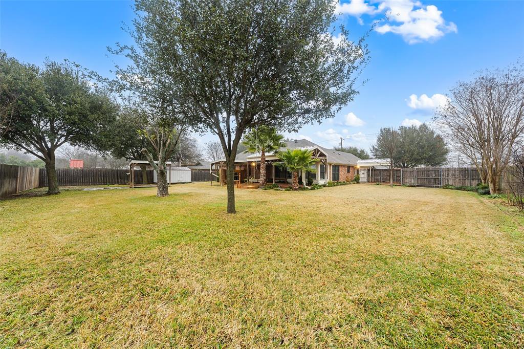 712 North Old Robinson Road Robinson, TX 76706 - Photo 22 of 26 Fenced backyard with an outdoor structure
