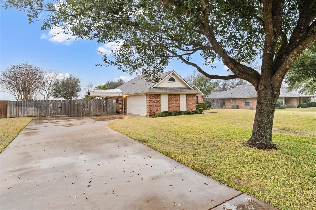 712 North Old Robinson Road Robinson, TX 76706 - Photo 24 of 26 View of front of home featuring concrete driveway, brick siding, a shingled roof, and an attached garage