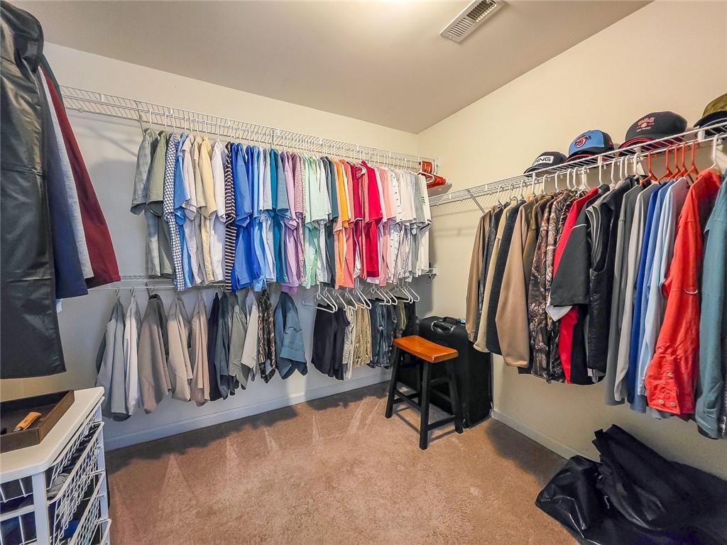 43 Ivy Mist Lane Acworth, GA 30101 - Photo 20 of 58 a view of walk in closet with clothes and shoes