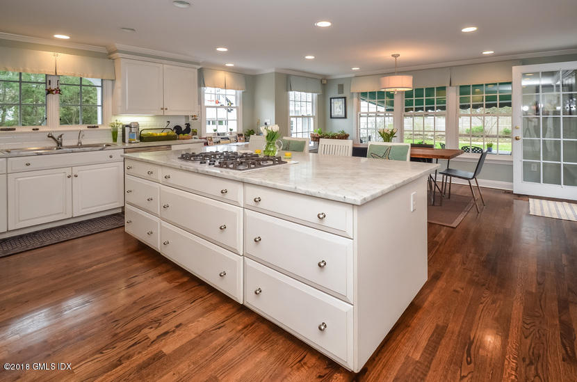 16 Willow Road Riverside, CT 06878 - Photo 9 of 30 a kitchen with stainless steel appliances granite countertop wooden floors and white cabinets