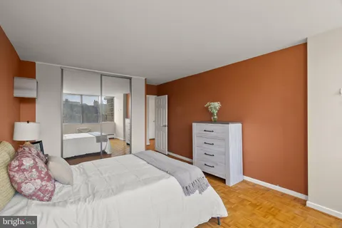 a view of a tall building next to a road