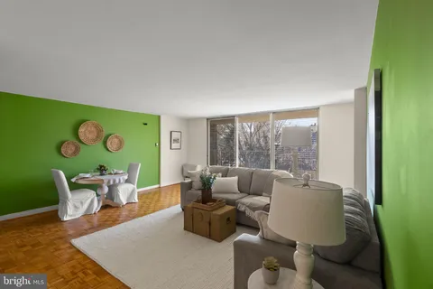 a living room with furniture and a kitchen view