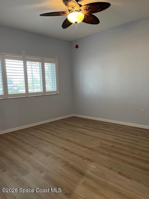 3111 Le Conte Street Melbourne, FL 32940 - Photo 15 of 33 an empty room with wooden floor fan and windows