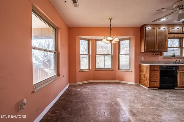a view of a kitchen with a sink and a window