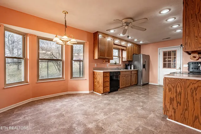 a kitchen with stainless steel appliances a sink and a refrigerator