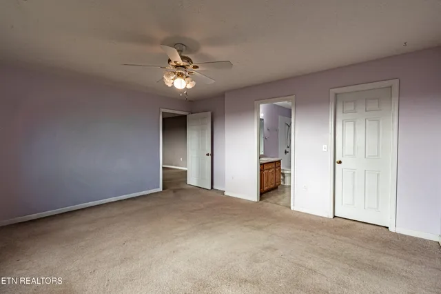 a bathroom with a sink a toilet a mirror and shower