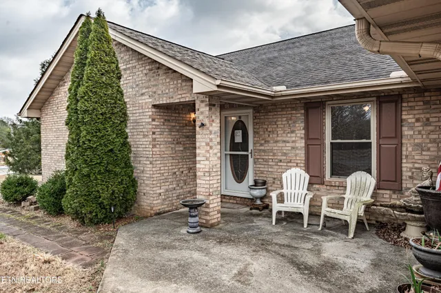 a front view of a house with outdoor seating