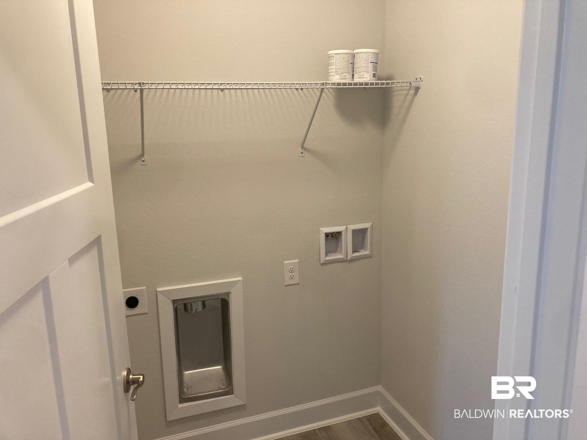 649 Revere Street Foley, AL 36535 - Photo 7 of 18 Washroom featuring dark wood-style floors, hookup for an electric dryer, baseboards, and washer hookup