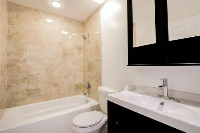 a bathroom with a sink a toilet and bathtub