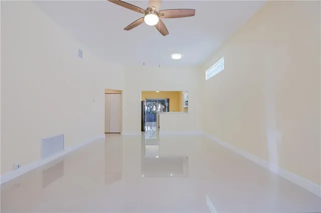 a view of a hallway with a chandelier fan