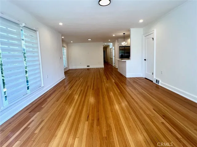 a view of a room with wooden floor