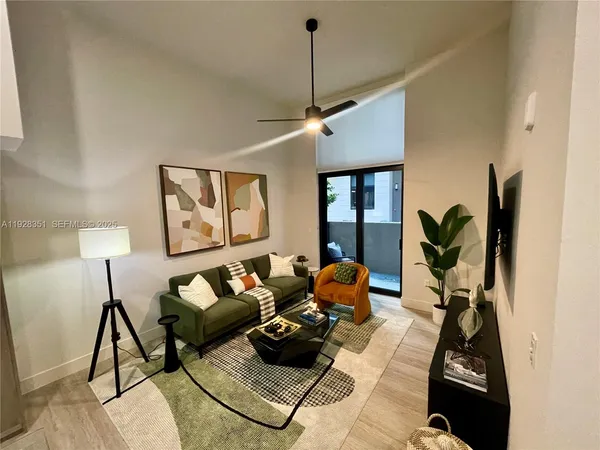 a living room with furniture and a potted plant