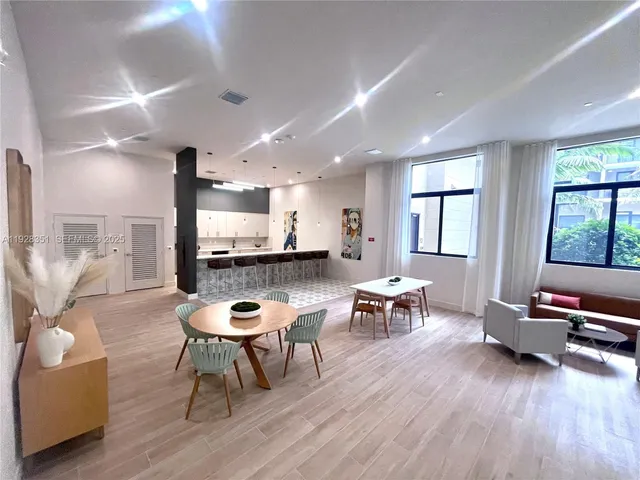 a view of a living room and kitchen with furniture