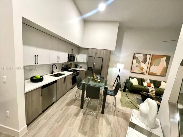 a kitchen with cabinets a sink a counter and appliances