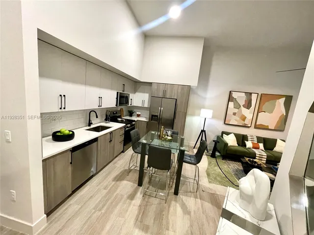 a kitchen with cabinets a sink a counter and appliances