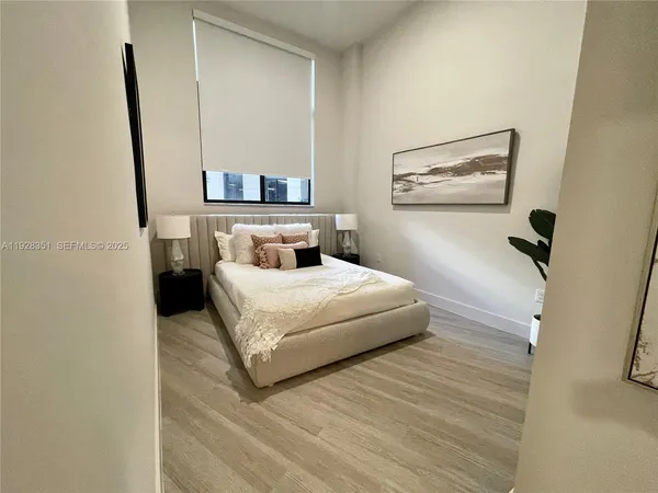 a bedroom with a bed and a mirror