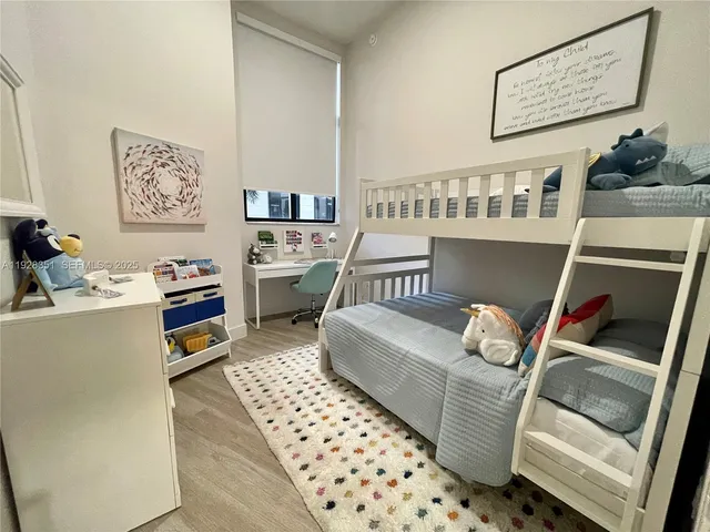 a living room with furniture and painting on the wall