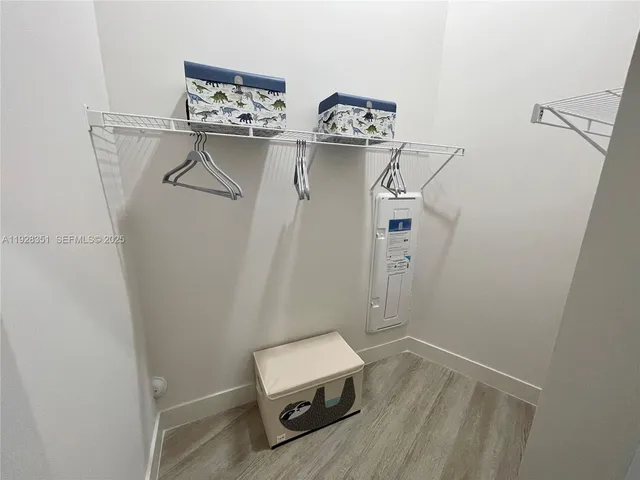 a room with a wooden floor and white walls