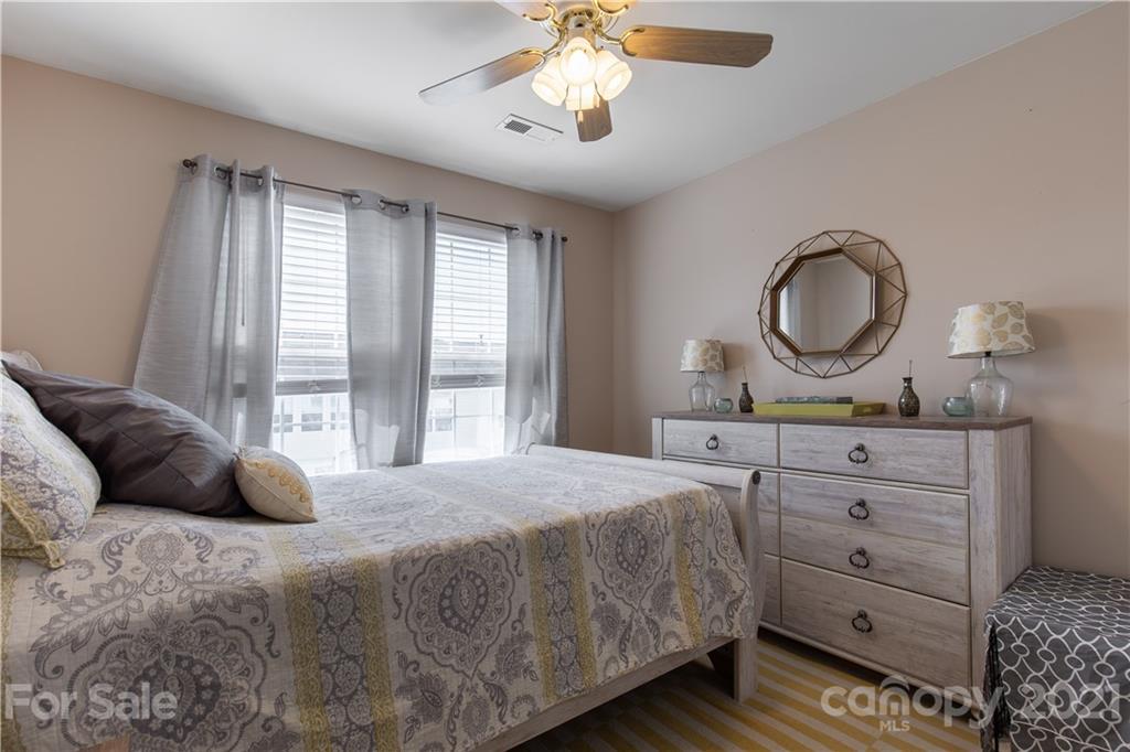 501 Poseidon Way Fort Mill, SC 29708 - Photo 12 of 19 a bedroom with a large bed and a chandelier