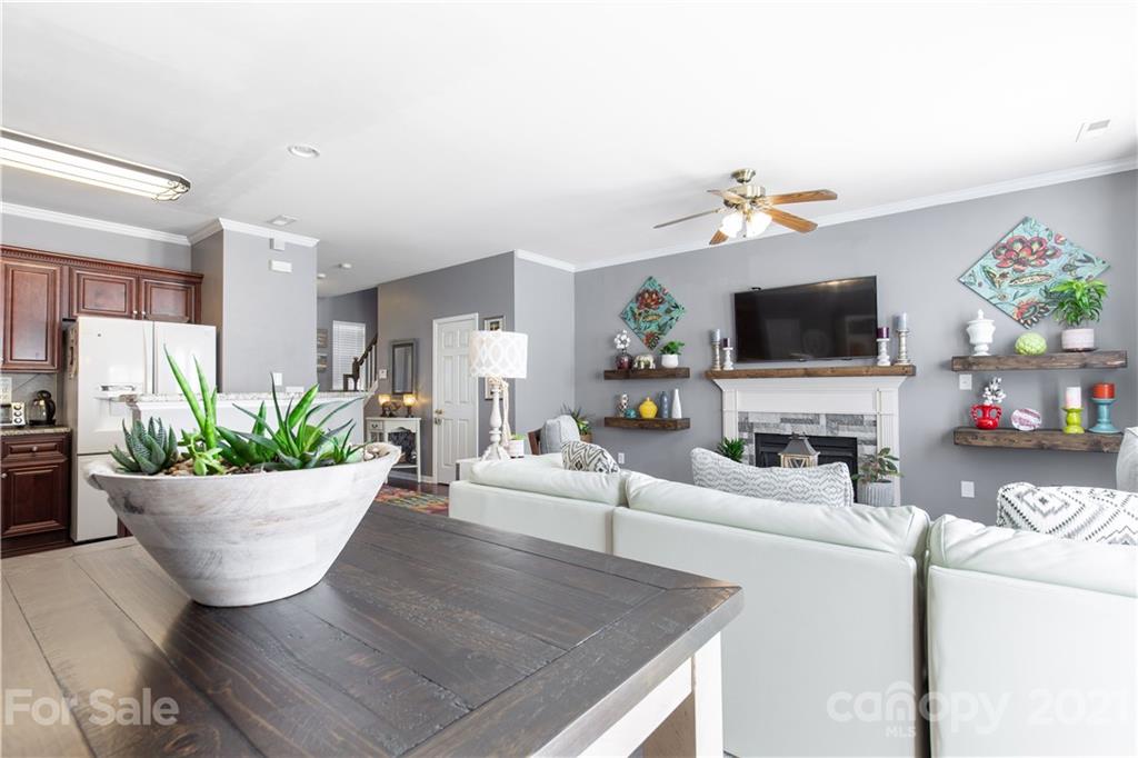 501 Poseidon Way Fort Mill, SC 29708 - Photo 6 of 19 a living room with furniture a fireplace and a flat screen tv
