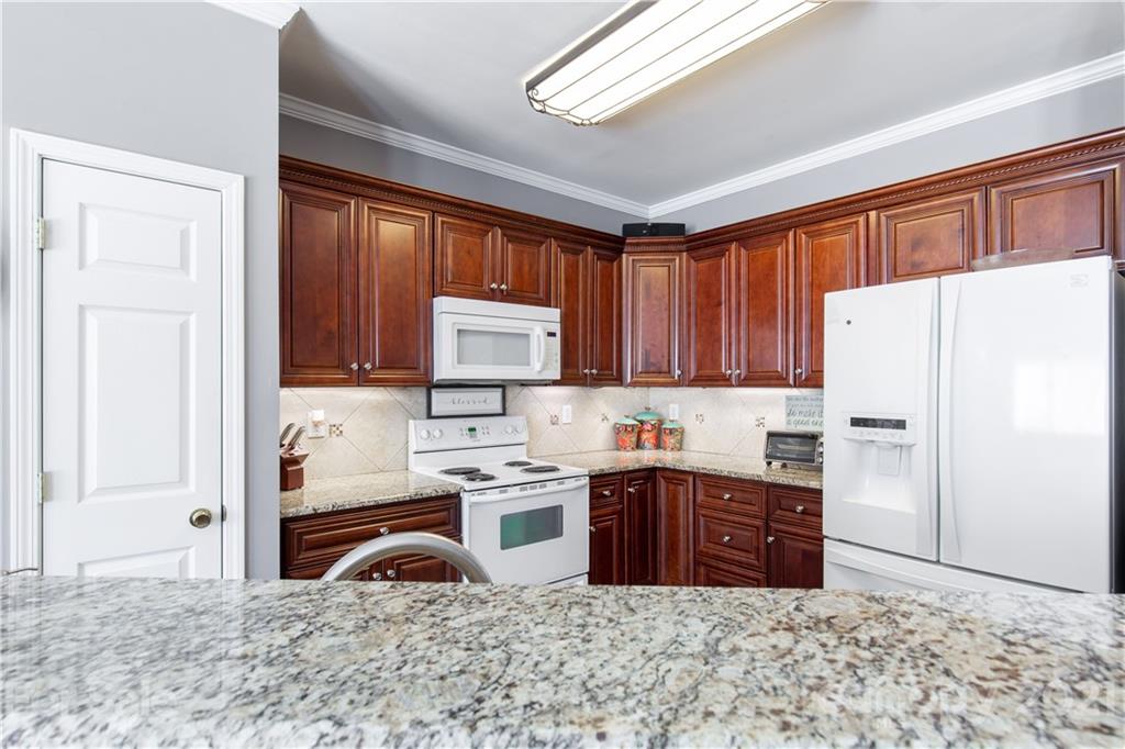 501 Poseidon Way Fort Mill, SC 29708 - Photo 9 of 19 a kitchen with stainless steel appliances granite countertop a refrigerator sink and cabinets