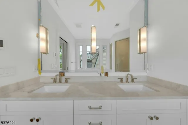 a spacious bathroom with sinks mirror and a bathtub