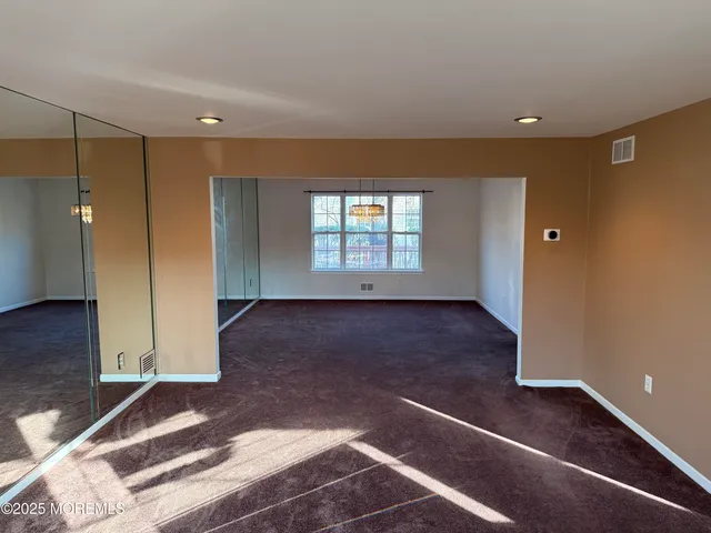 an empty room with windows and entrance
