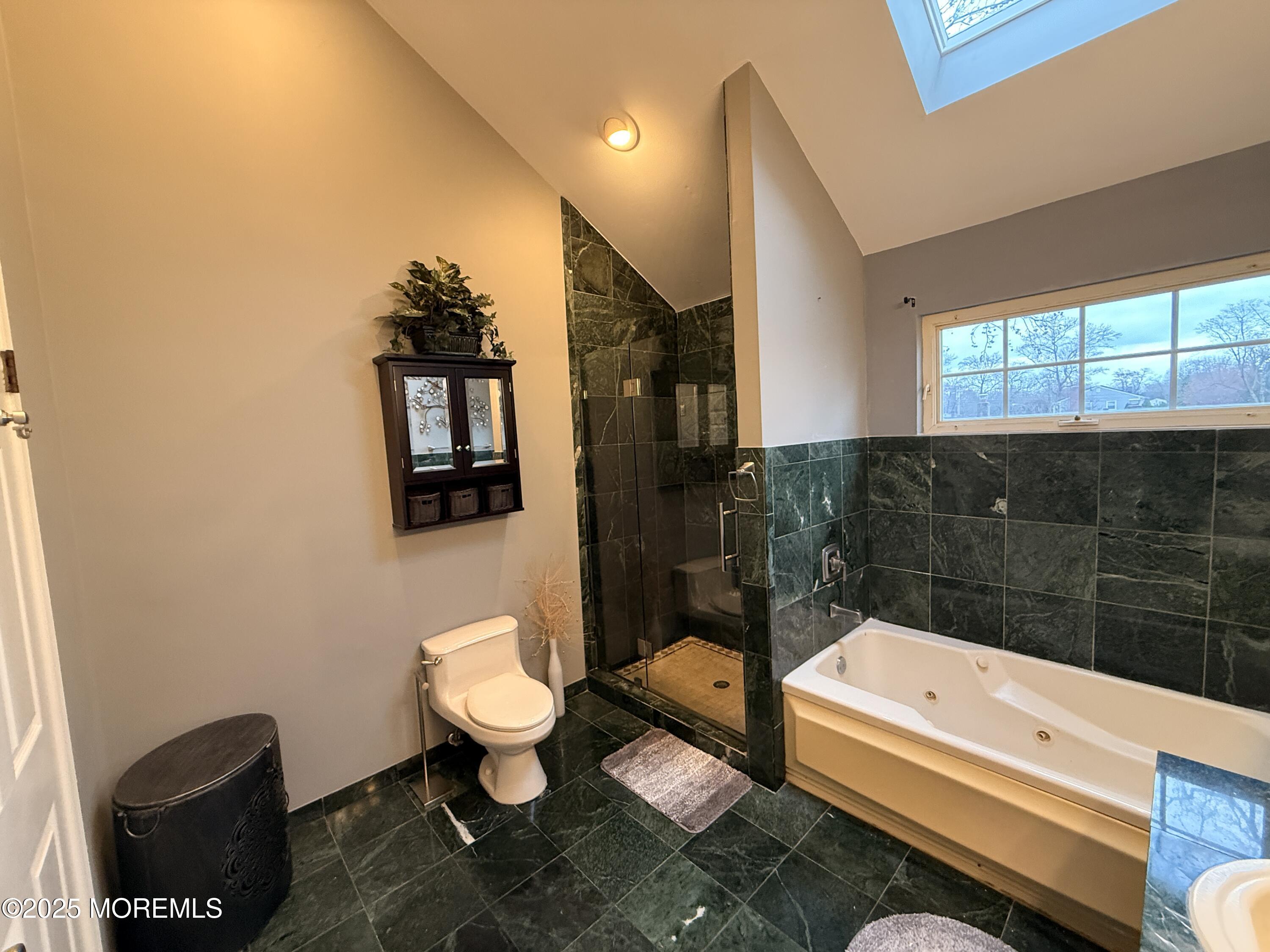 1811 Bellmore Street Oakhurst, NJ 07755 - Photo 13 of 49 a bathroom with a sink a toilet a mirror and shower