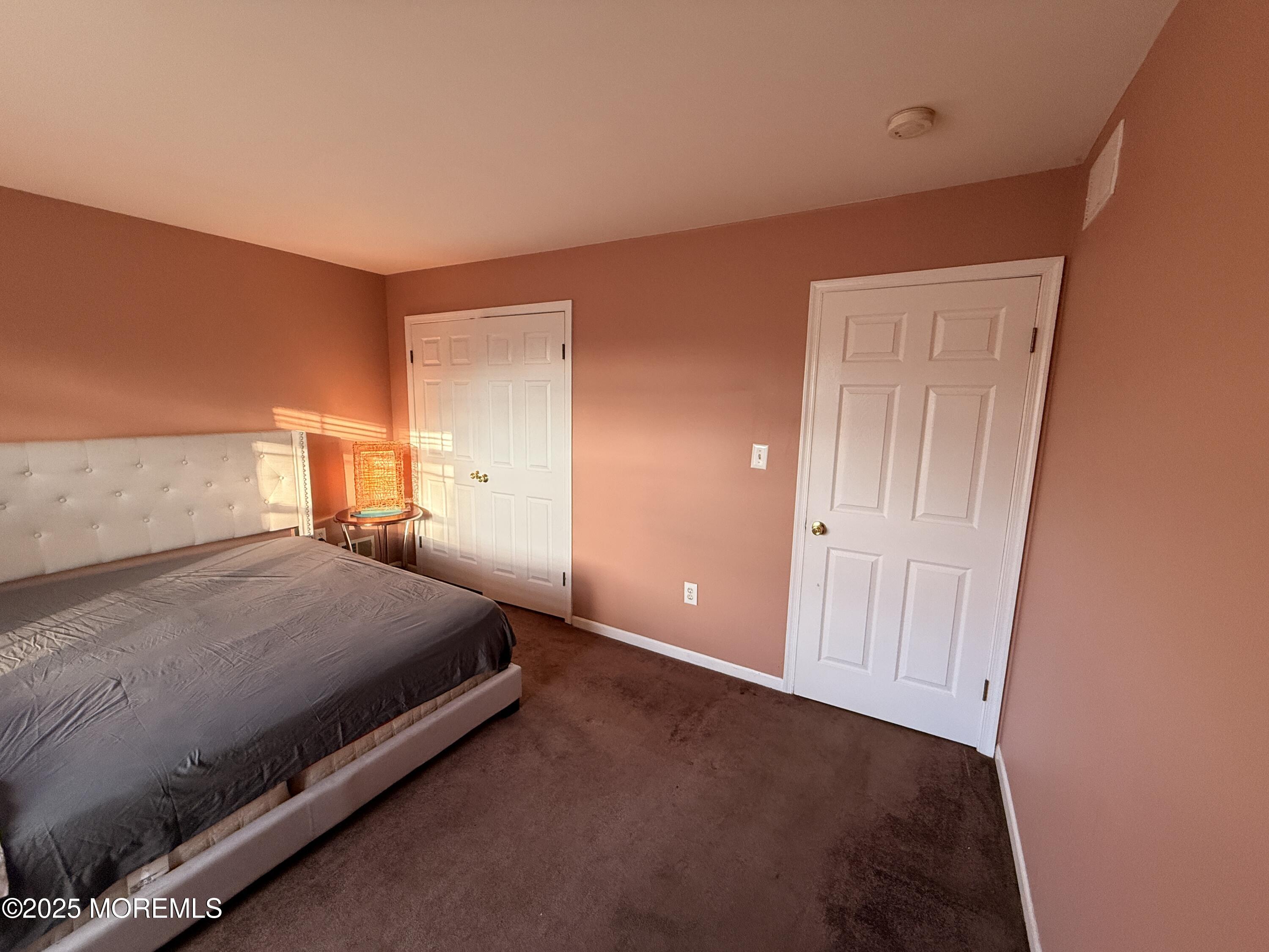 1811 Bellmore Street Oakhurst, NJ 07755 - Photo 18 of 49 a bedroom with a bed and cabinets